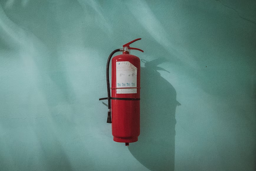 fire extinguisher on the wall of a company's building