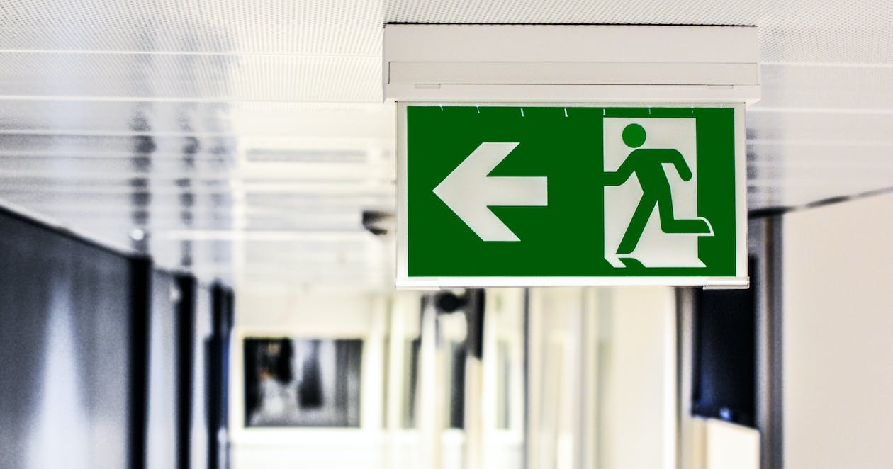 A green fire safety exit sign