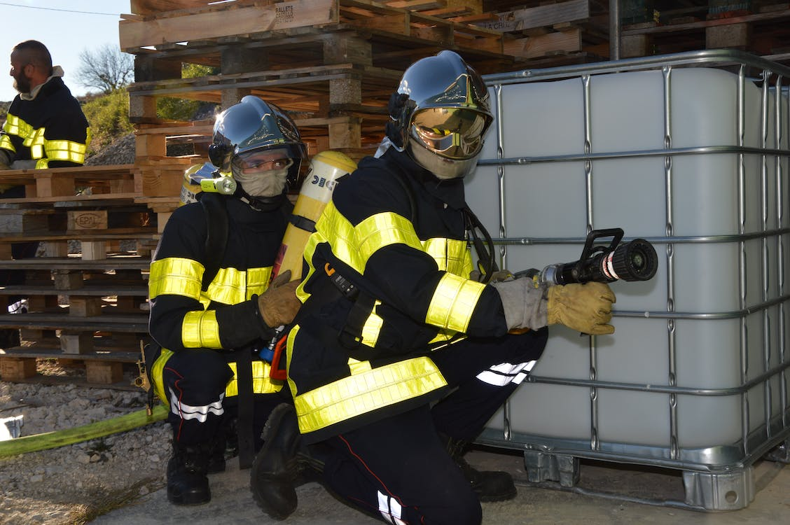 Two firefighters participating in a fire safety drill